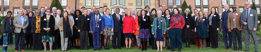 Delegates at the Hope Ecumenical Network Symposium stand together on the Rector's Lawn at Liverpool Hope University.